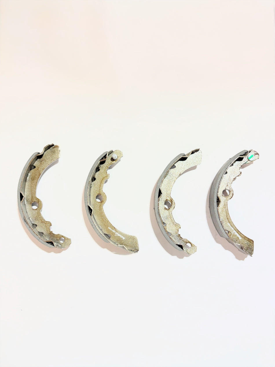 AUTOKOI brake pads and shoe KBPF17304 for vehicle braking system, showing the set of brake components with detailed metal and pad surfaces.