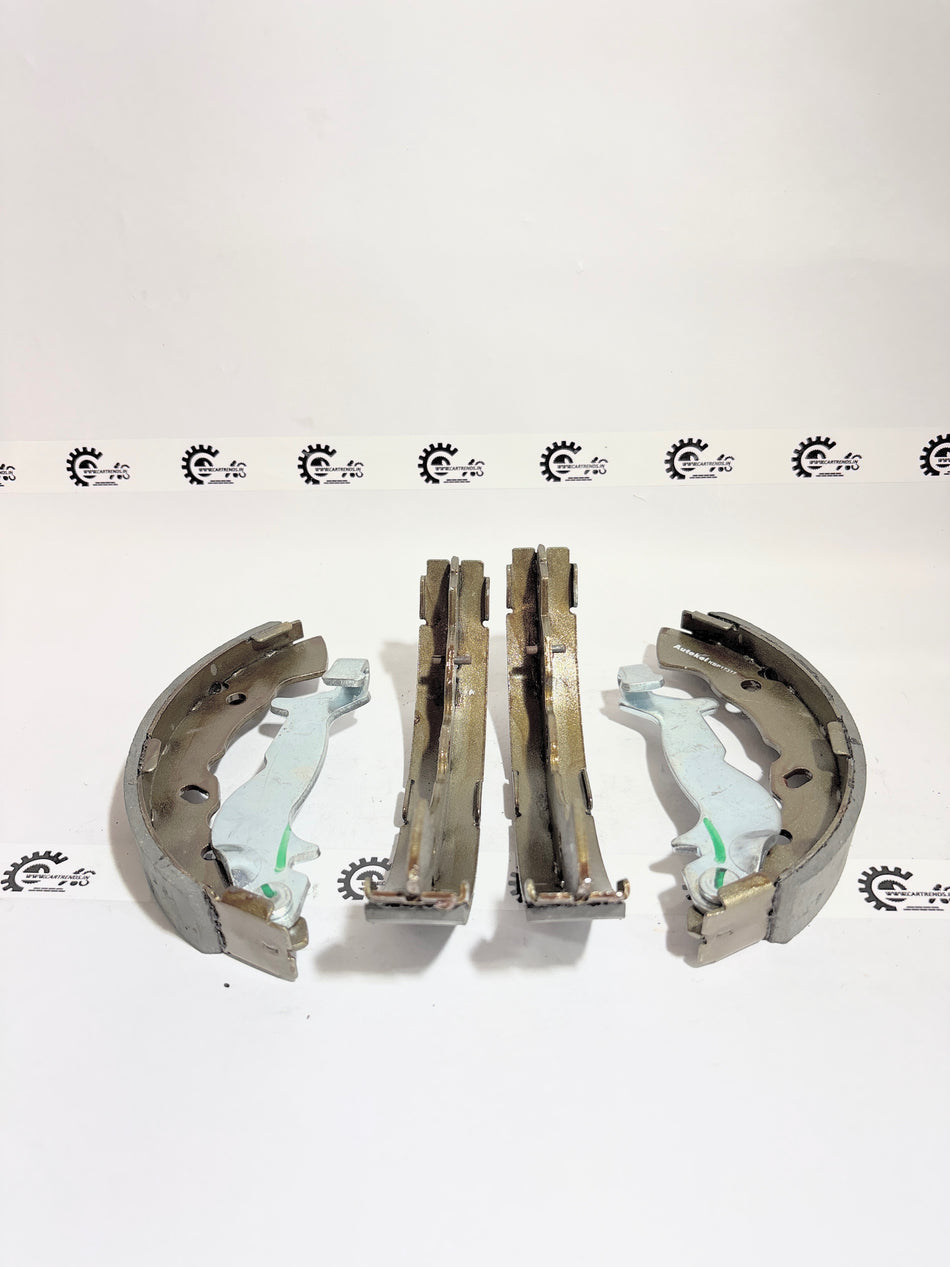 AUTOKOI brake pads and shoe KBPF17317, automotive brake components with detailed design and branding visible.
