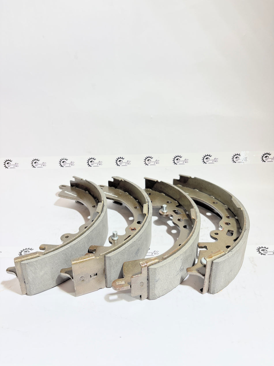 AUTOKOI brake pads and shoe KBPF17345, automotive brake components, with visible metal backing and friction material.