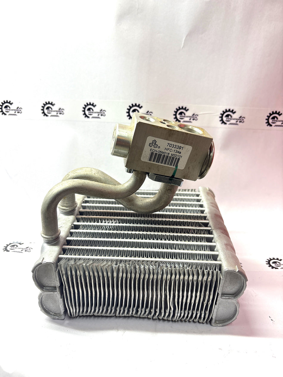 CarTrends evaporator assembly for vehicle air conditioning system, showing metal fins and refrigerant connections.