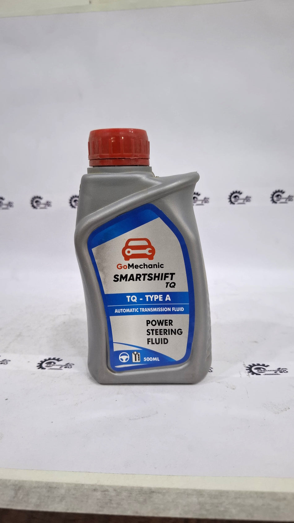 CarTrends GoMechanic Smartshift TQ Type A automatic transmission and power steering fluid bottle with label visible.