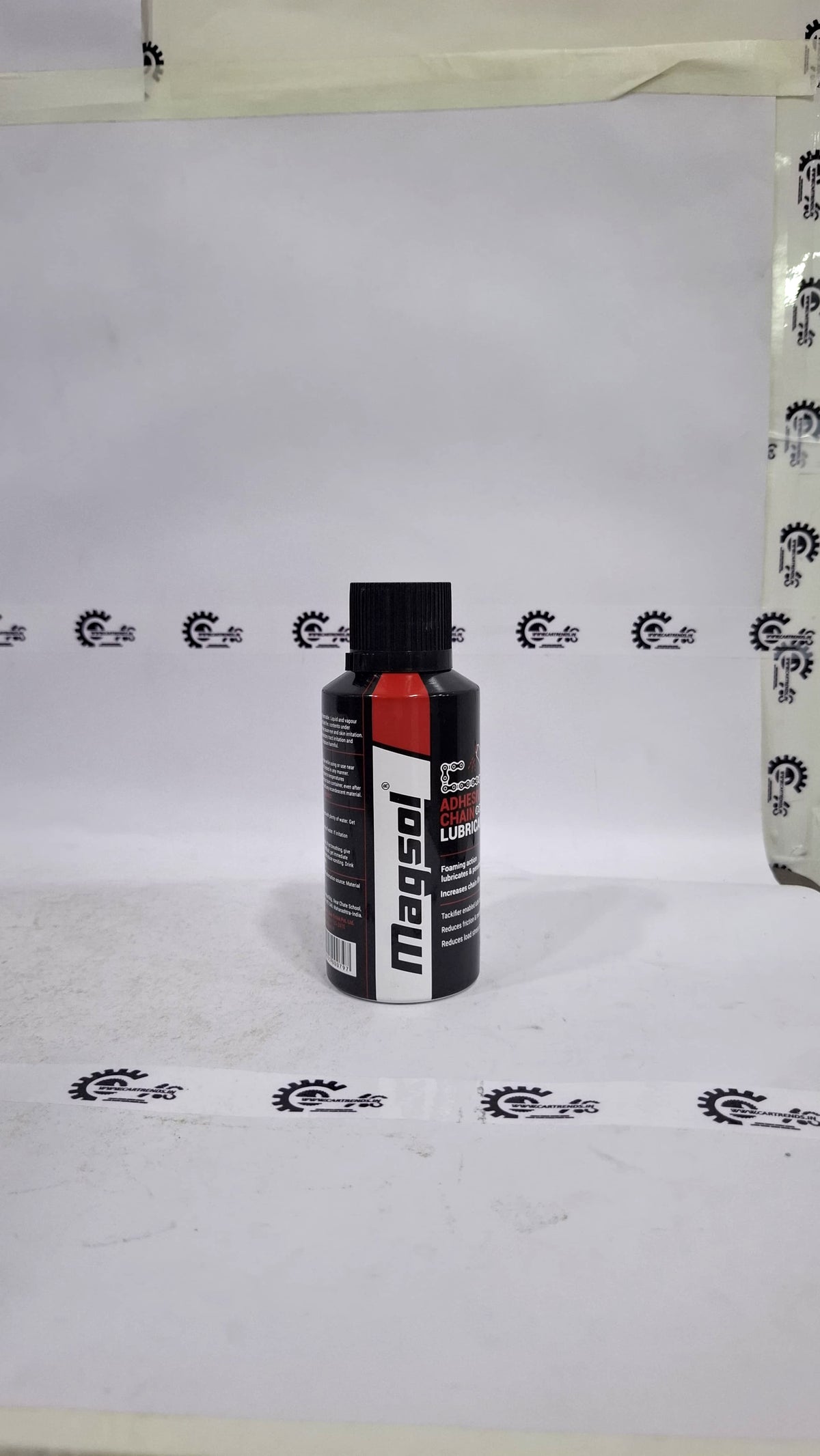 CarTrends Magsol Adhesive Chain Lubricant spray applied to a motorcycle chain, showcasing its effective lubrication properties.