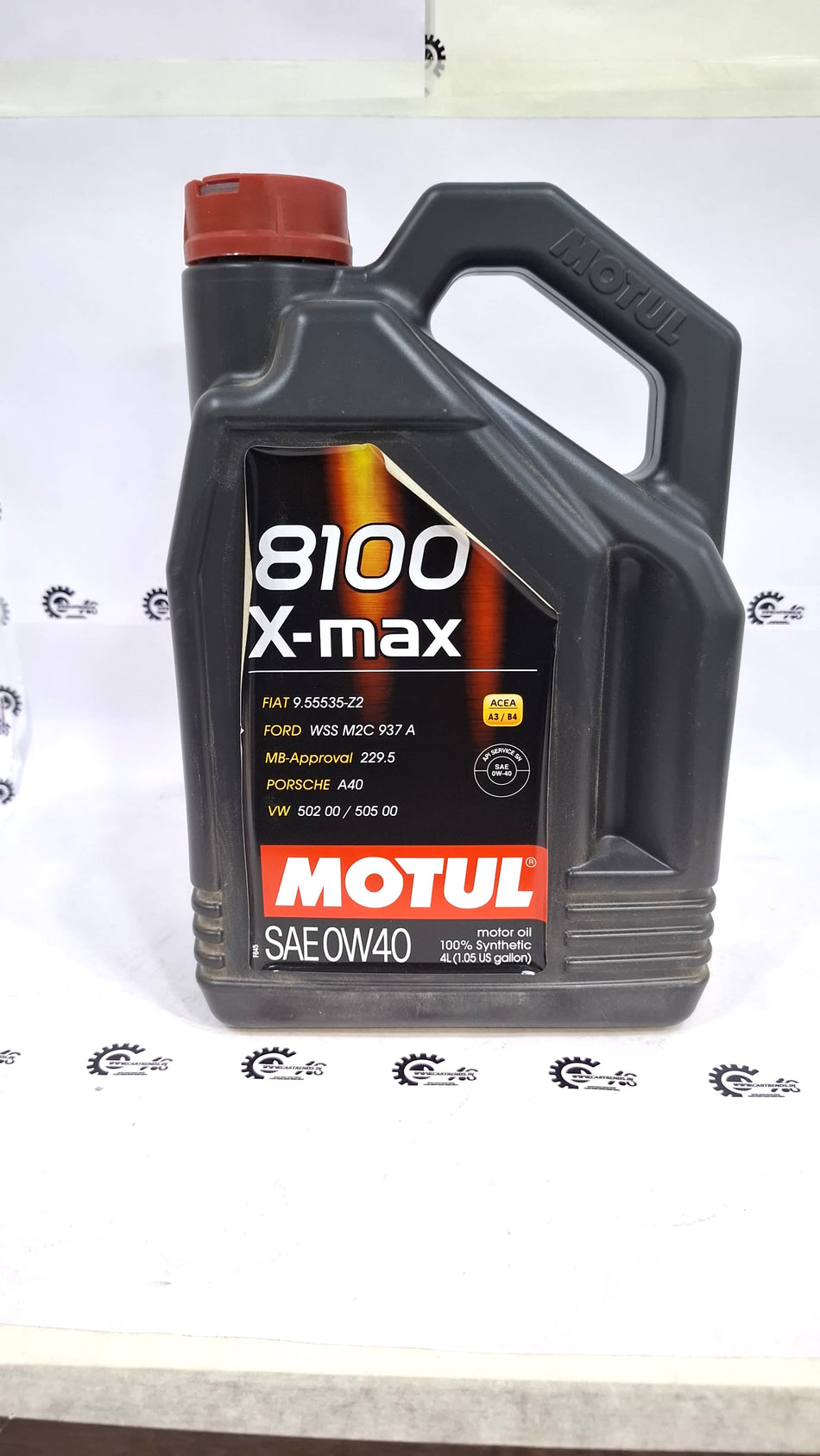 CarTrends Motul 8100 X-max 0W-40 synthetic engine oil in a container, designed for high-performance vehicle lubrication.