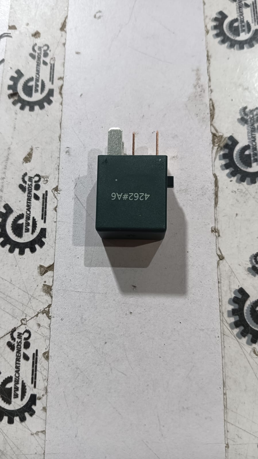 Honda relay assembly Micro Amaze by CarTrends, compact electronic component with metal and plastic parts for vehicle electrical system.
