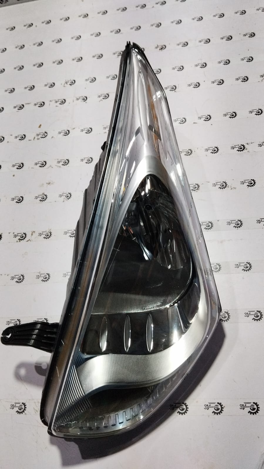 Hyundai EON lamp head by CarTrends, left side, automotive headlight component with clear lens and mounting points.