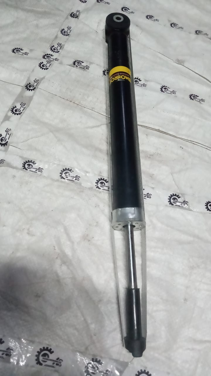 CarTrends Monroe M2N3G1274 shock absorber showing a close-up of the black metal body and mounting points.