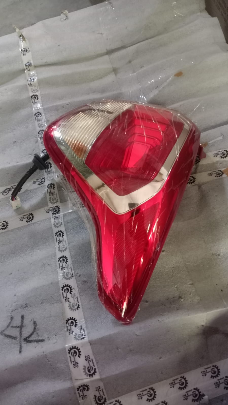 CarTrends rear right tail lamp for Xcent, side view of the spare part showing the lens and mounting details.