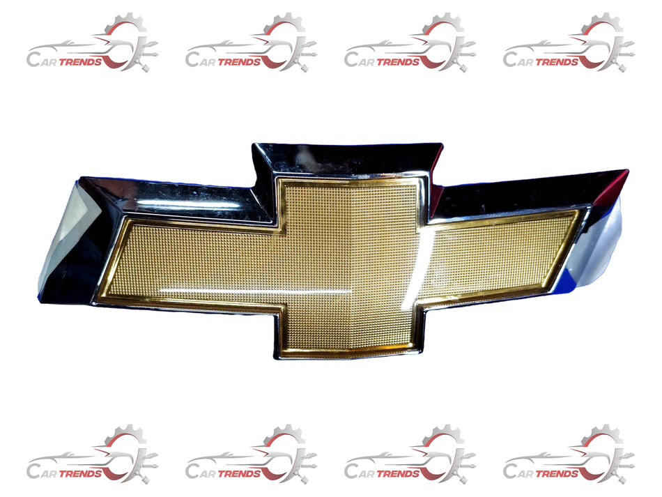 CarTrends Chevrolet Beat front bumper fascia emblem, spare parts image showing the vehicle emblem and bumper fascia.