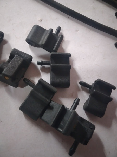 CarTrends rear washer nozzle for Aveo, spare part replacement, shown in close-up on the black vehicle.