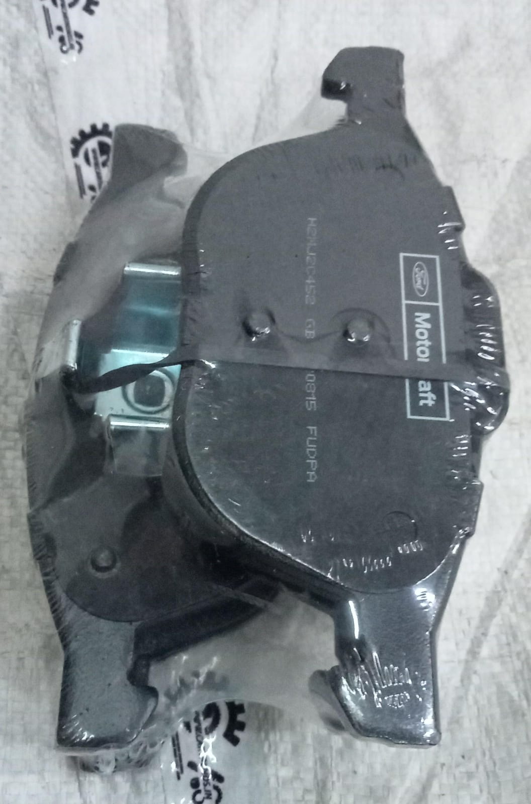 Ford EcoSport front brake pad set, side view showing new brake pads for vehicle safety and braking performance.