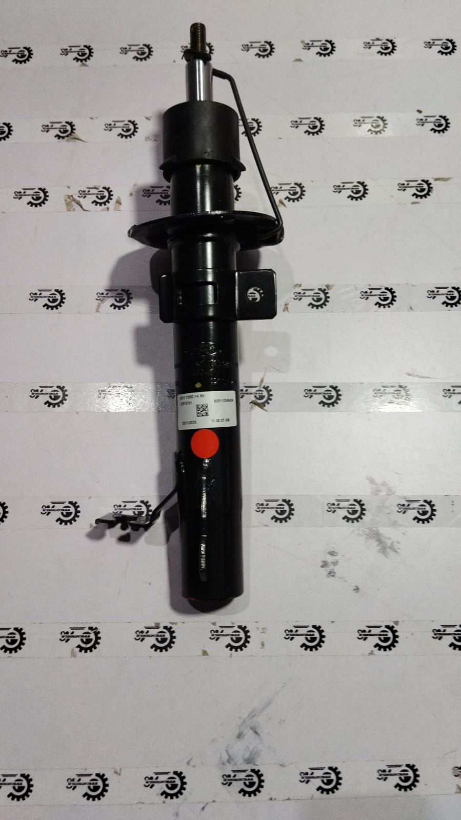 Front shock absorber for Ford Figo, showing the black coil spring and mounting components on the vehicle suspension.