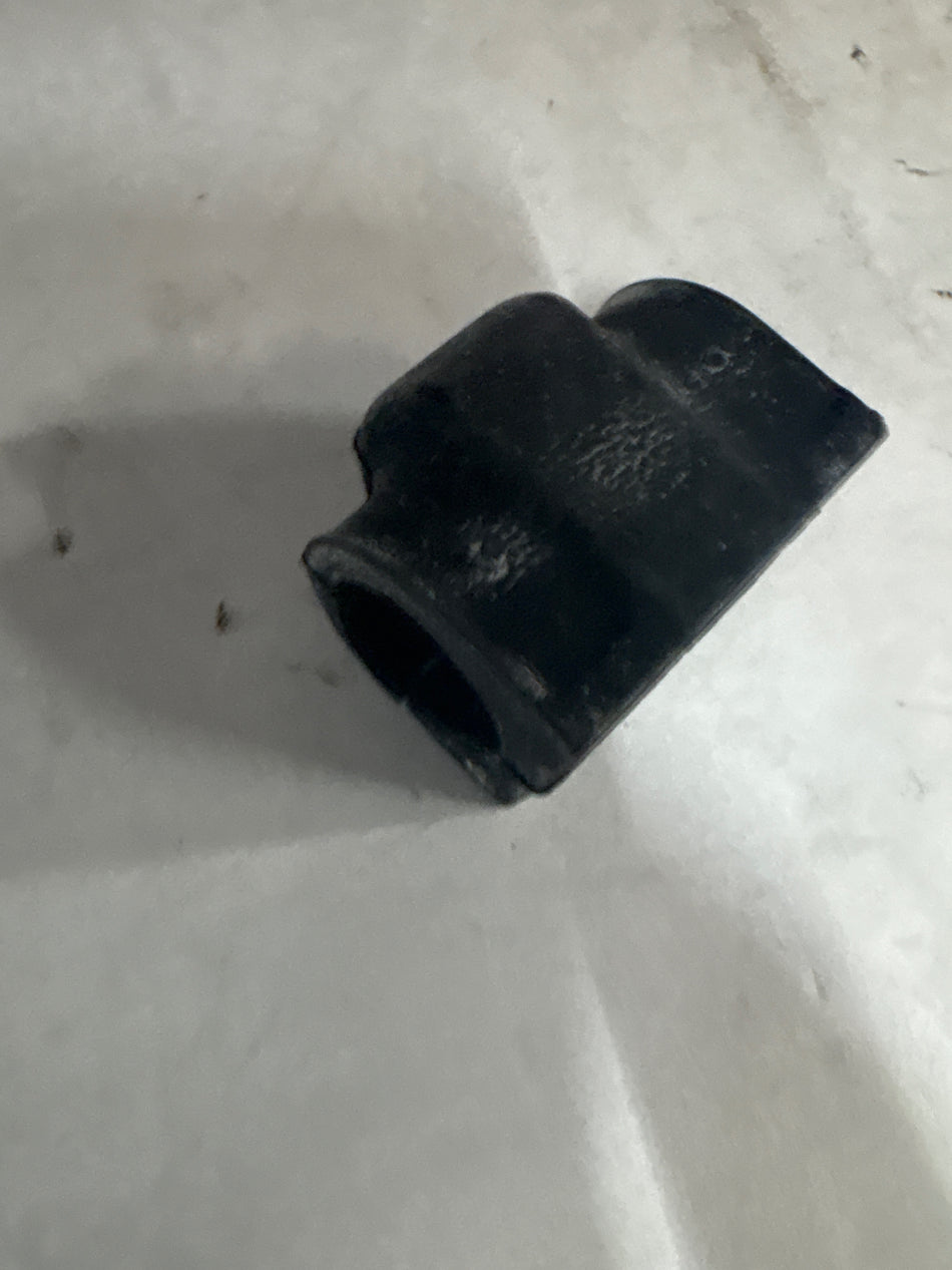 Ford J7BZ5484D insulator stabilize, automotive part showing the black plastic insulator with metal clips for stabilizing components.