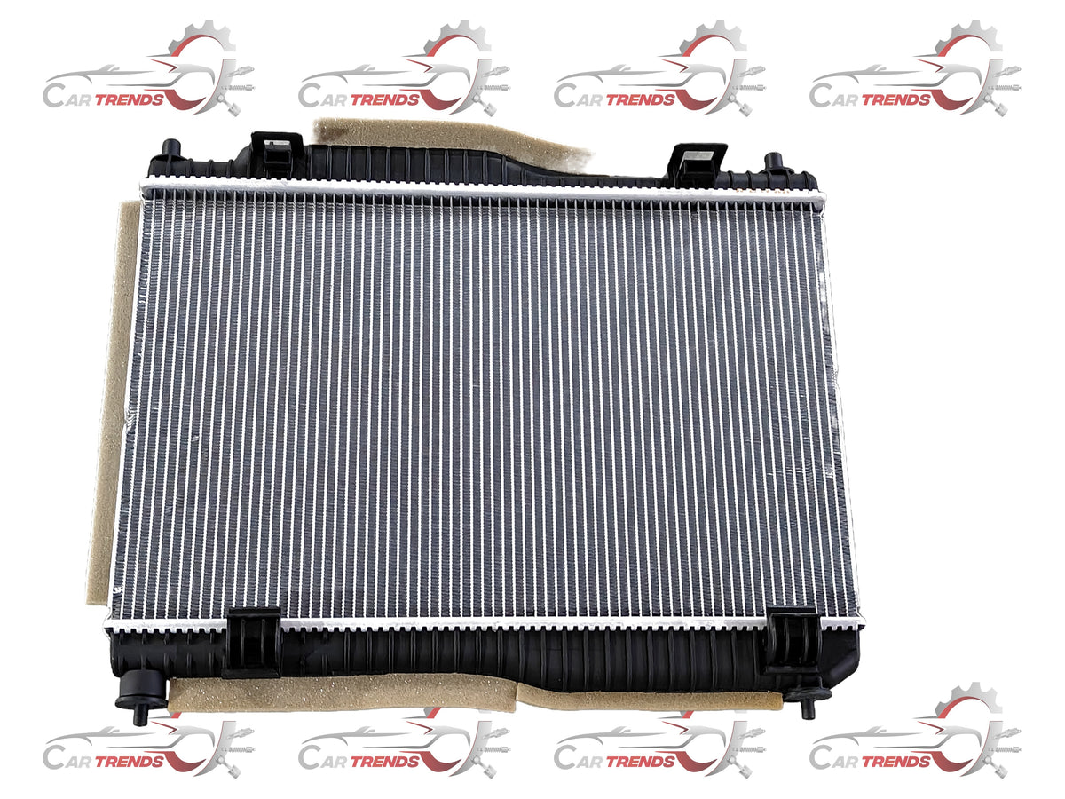 Ford radiator 8V5Z8005B with metal fins and hoses, visible for cooling system replacement in a Ford vehicle.