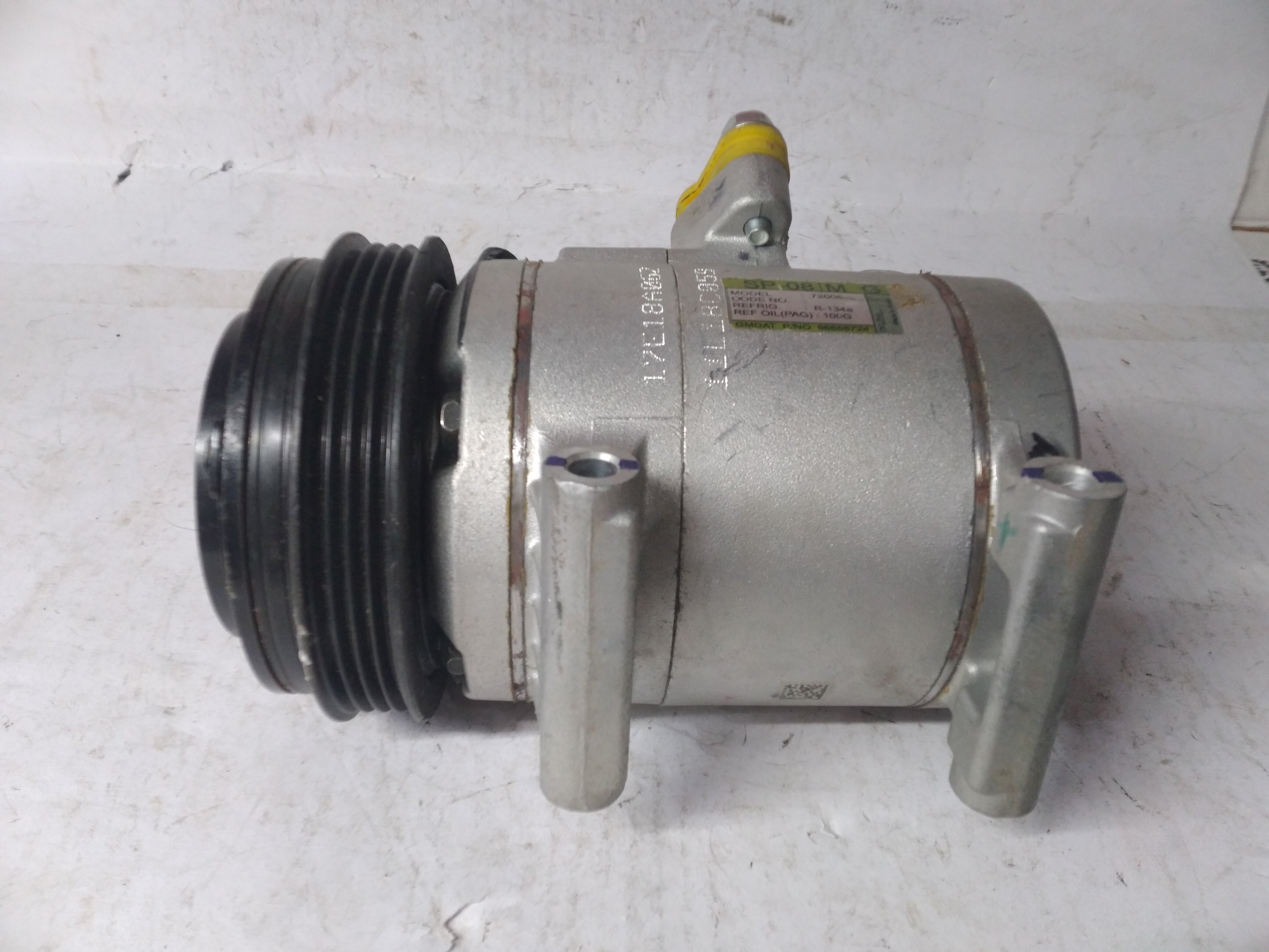 General Motors AC compressor Spark J96858724, automotive part for vehicle air conditioning system, shown in the image.