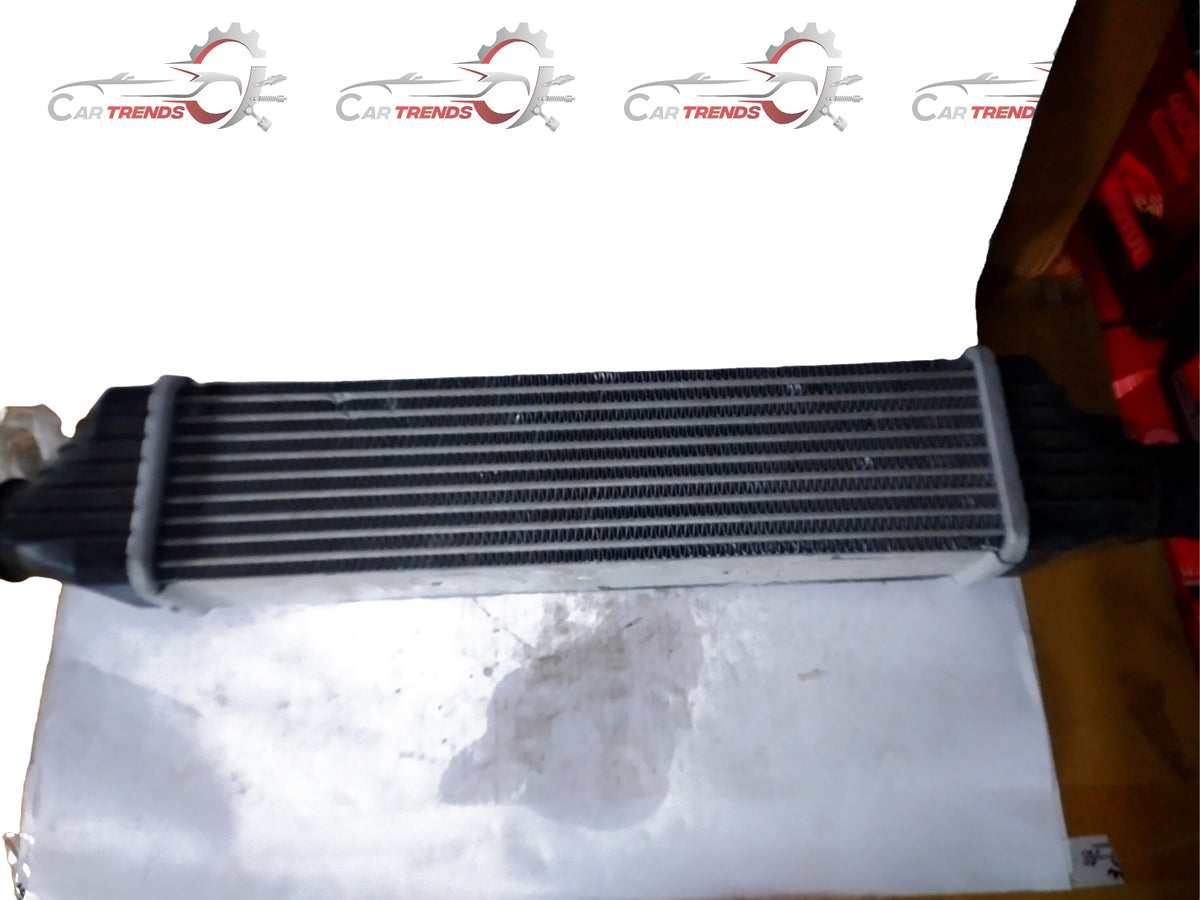 General Motors cooler assembly with air sail, part J90870773, for vehicle cooling system, shown from the front angle.