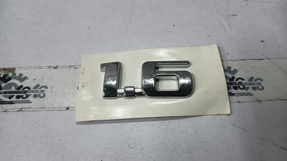 Chevrolet Corsa emblem license gate by General Motors, featuring a chrome badge with Chevrolet logo and model details.