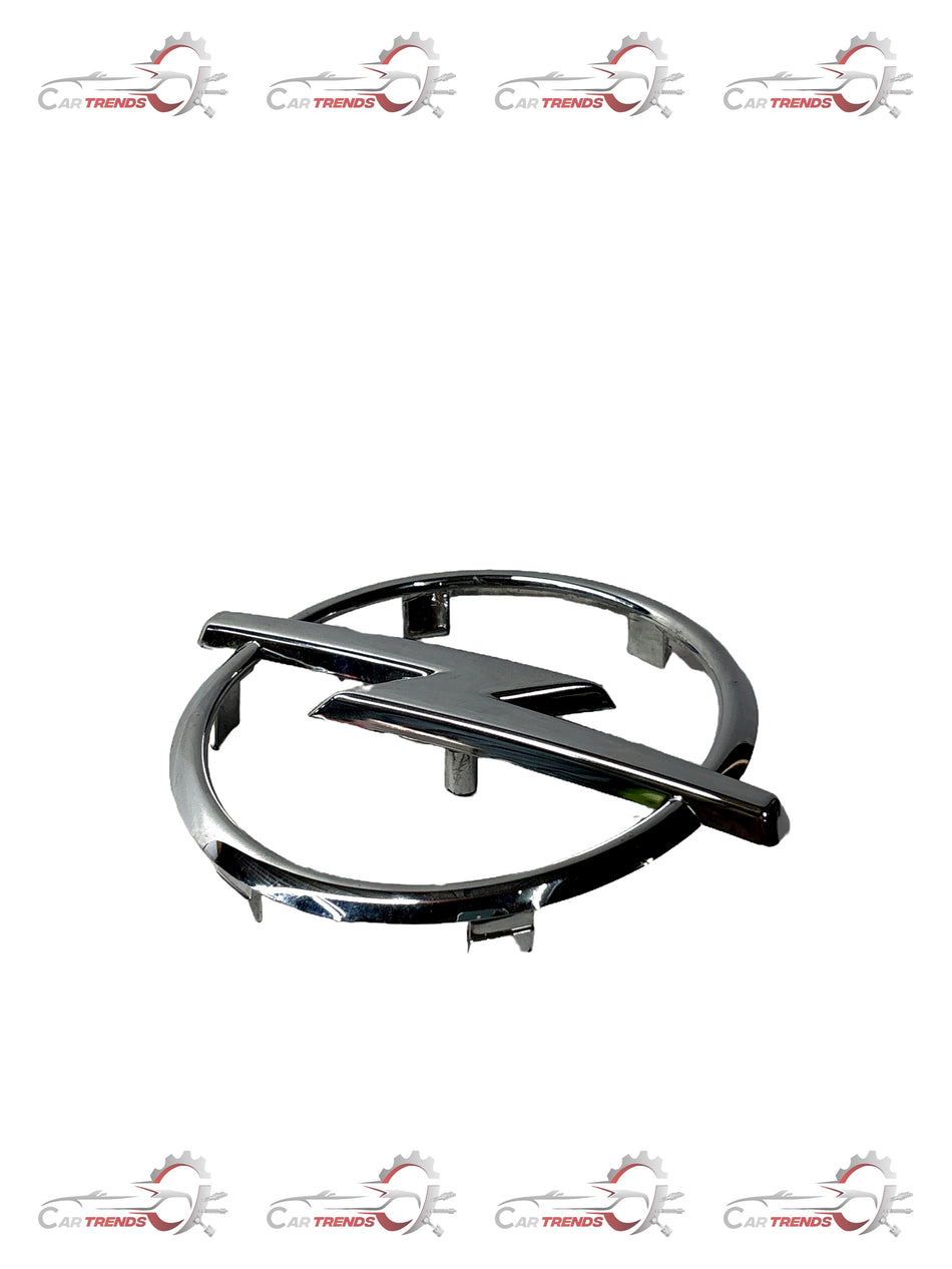 Opel Astra front grille emblem by General Motors, showing the chrome Opel logo on the black grille surface.