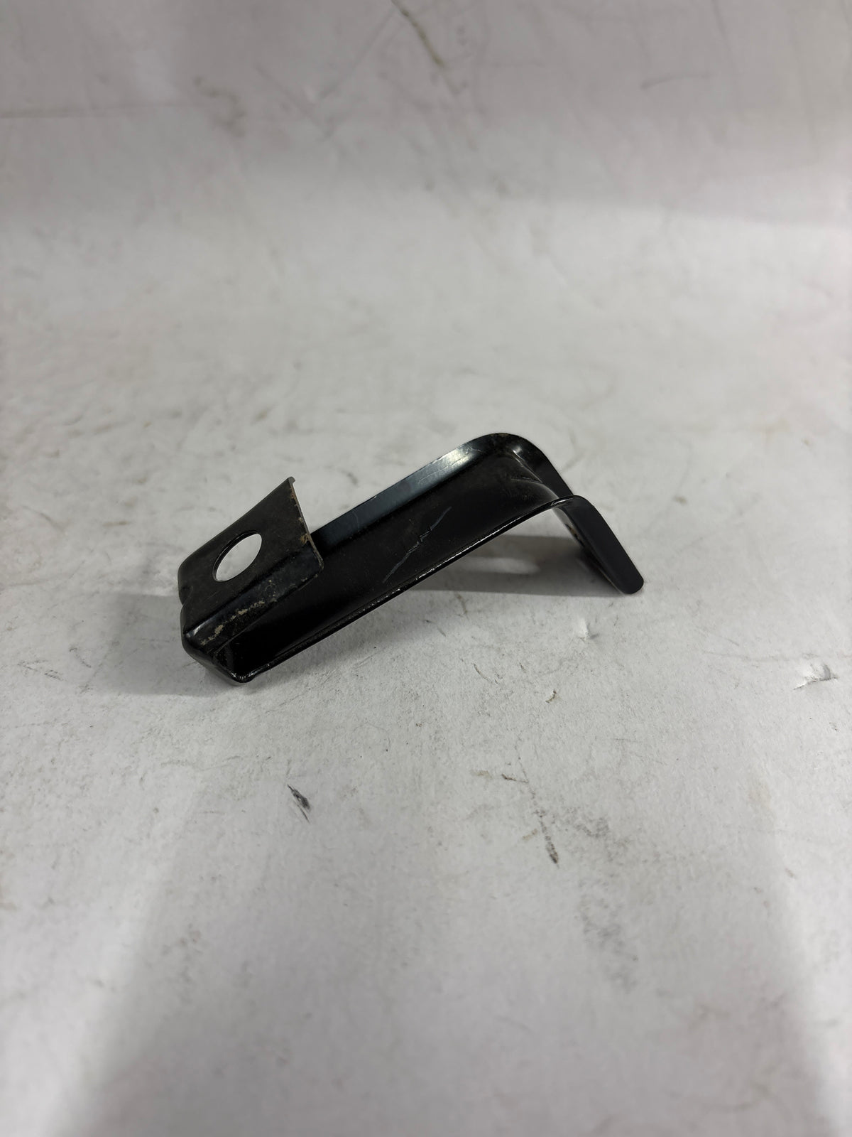 General Motors Optra front support bar, automotive part, shown in a close-up view with mounting points and metal construction.