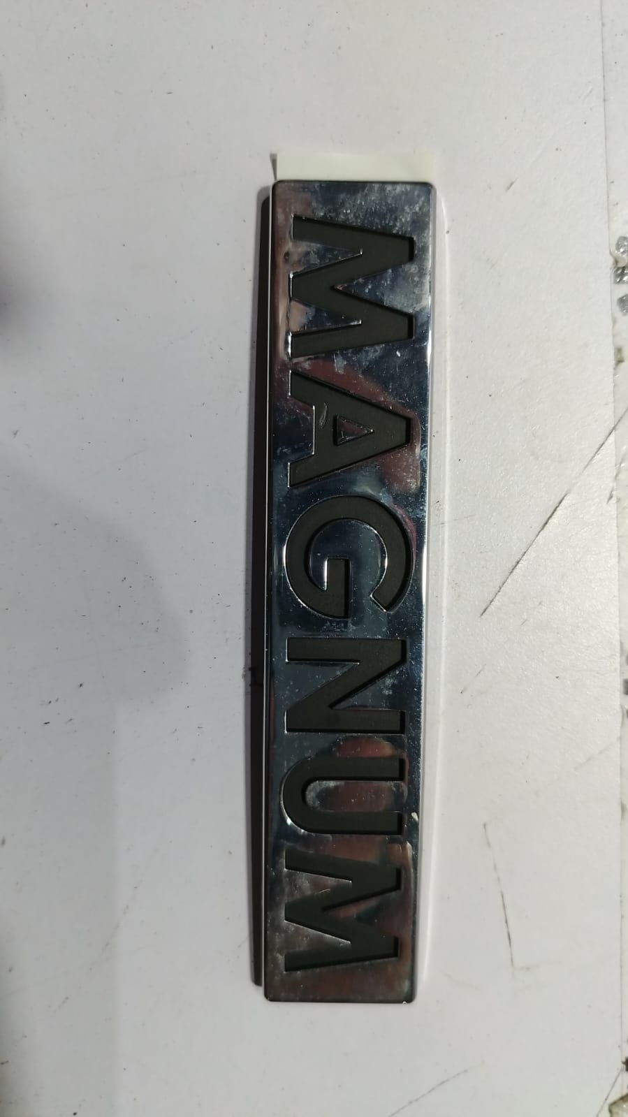 Lettering for Magnum Optra Petrol by General Motors, featuring the vehicle's branding and model details on the car.