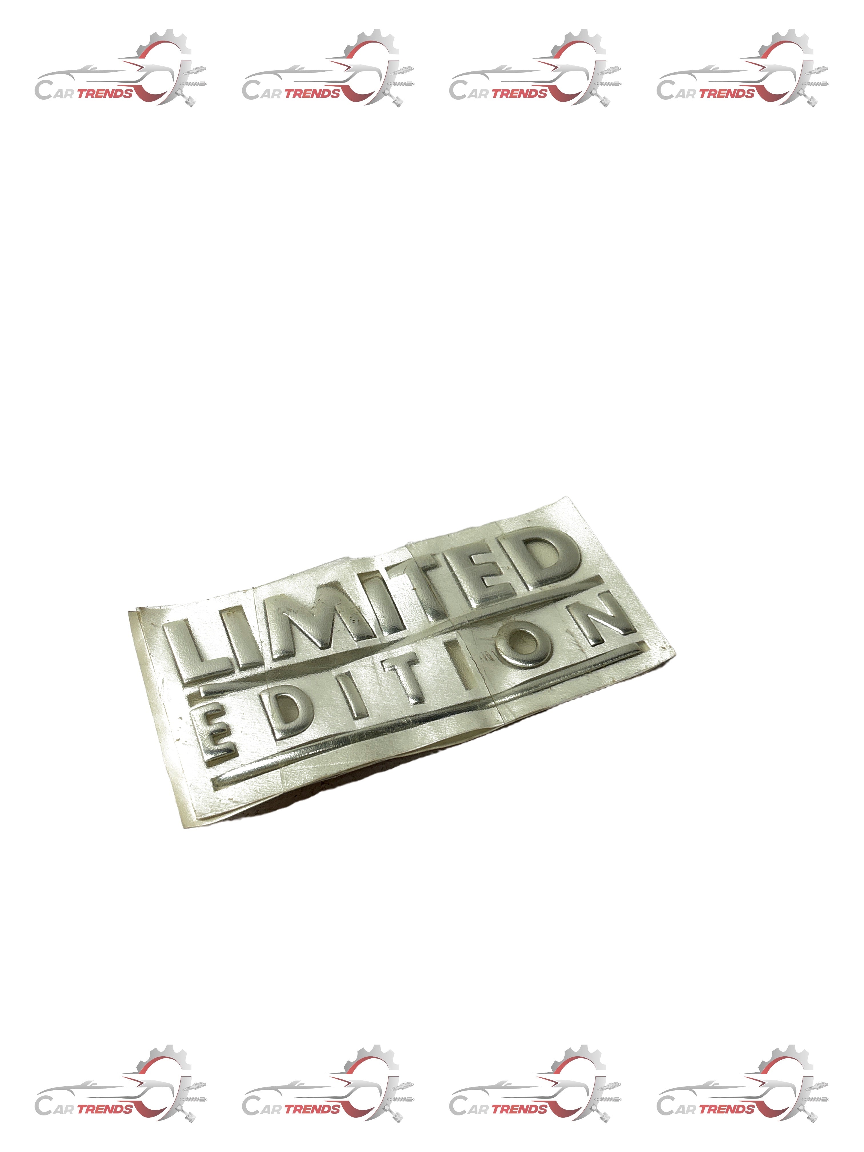 Limited edition General Motors Aveo nameplate, black and silver metal car badge with model and brand details.