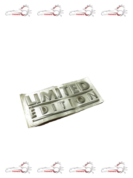 Limited edition General Motors Aveo nameplate, black and silver metal car badge with model and brand details.