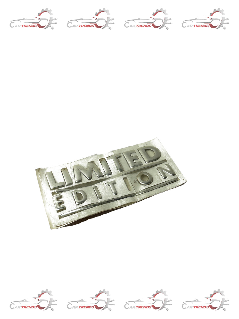 Limited edition General Motors Aveo nameplate, black and silver metal car badge with model and brand details.