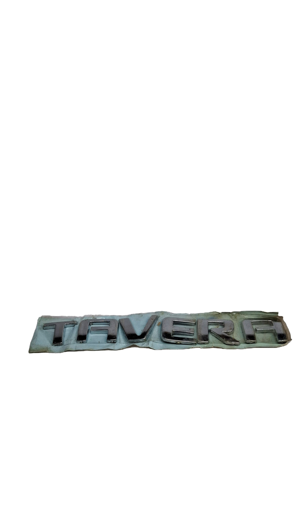 General Motors Tavera name plate, black metal badge with white lettering, designed for Tavera vehicle identification.