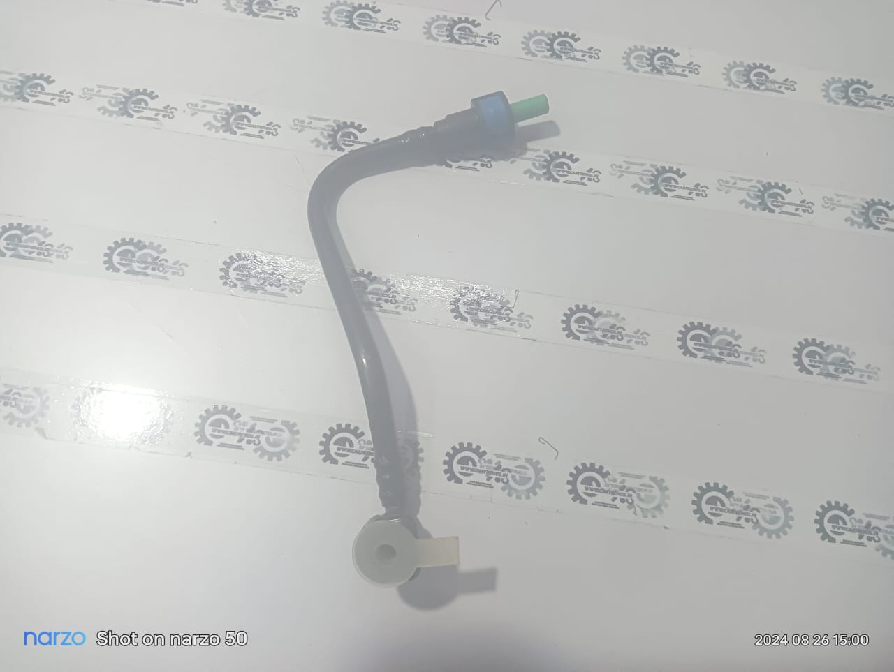 General Motors fuel feed pipe for Cruze, J13269615, showing the black plastic component with metal fittings and connectors.
