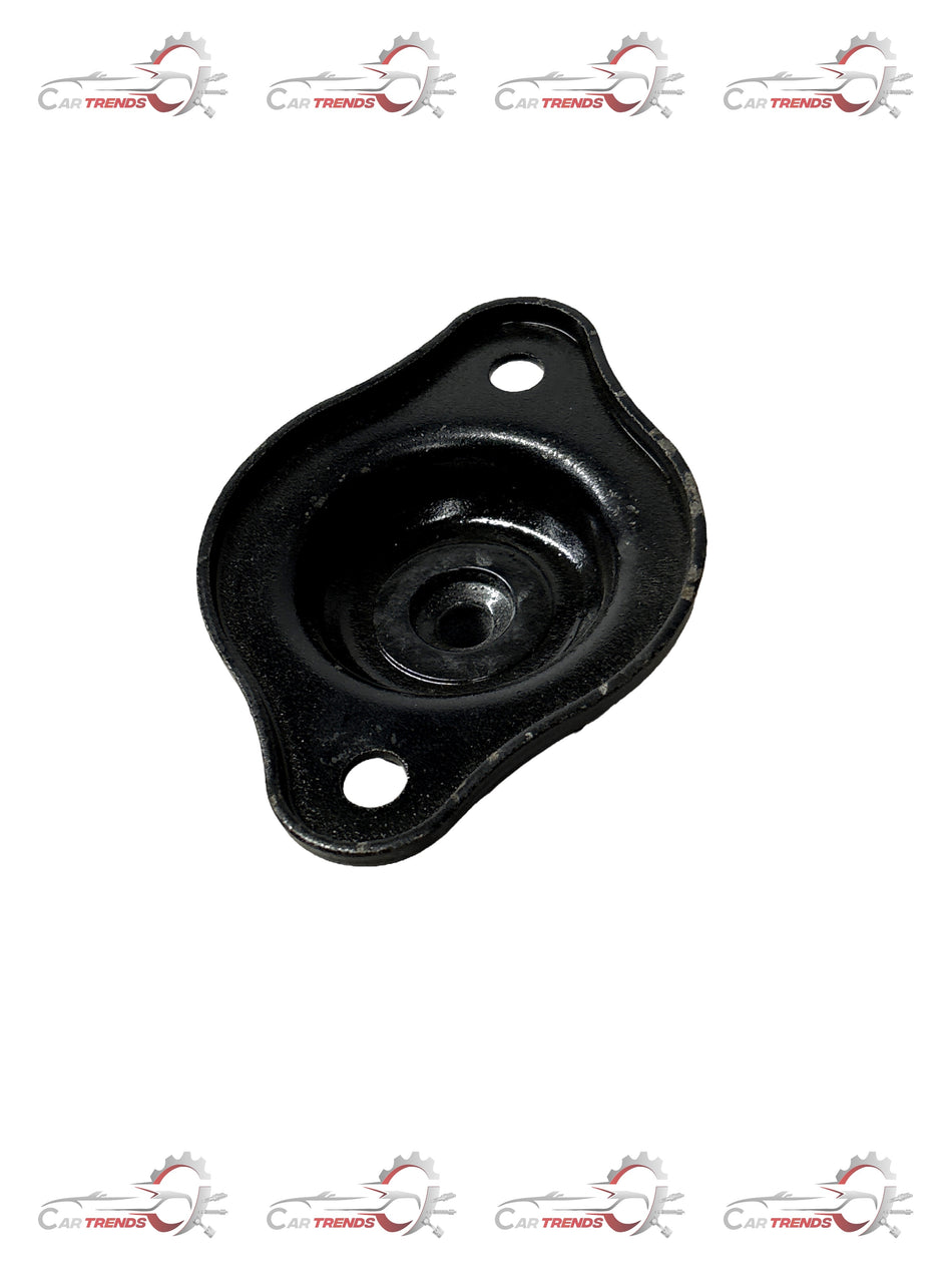 General Motors strut mount for Aveo, model J981094L0, showing the black metal component with mounting points and rubber insulator.