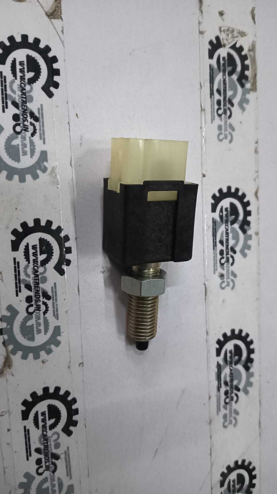 General Motors Tavera switch stop light, automotive part for vehicle lighting and signaling, shown in the image.