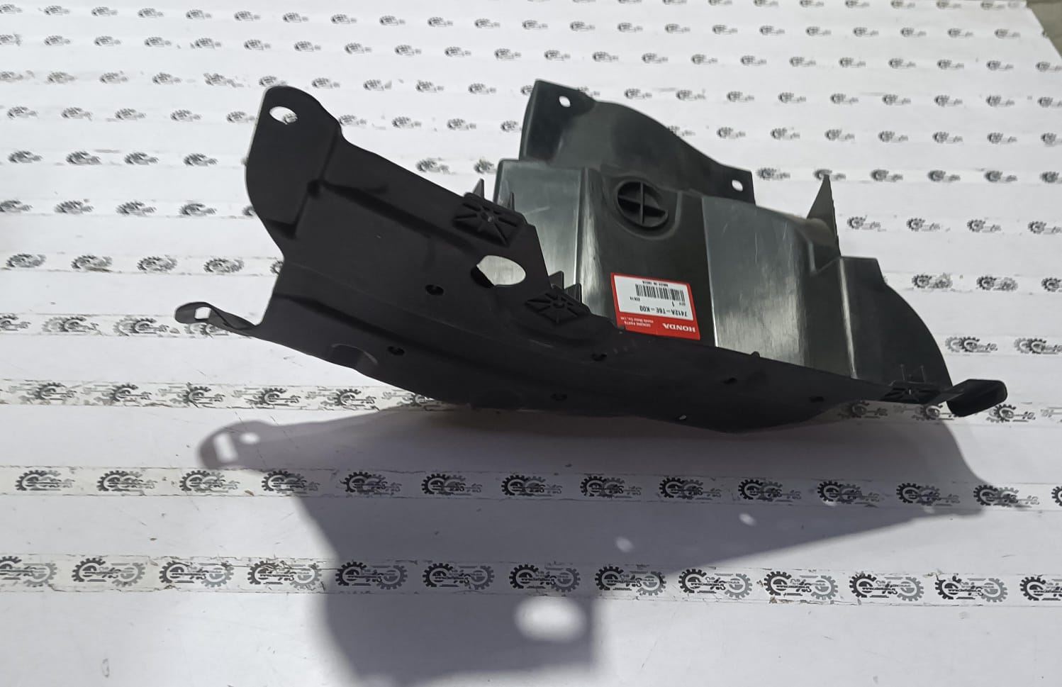 Honda splash guard assembly model 7412AT6EK00, designed to protect vehicle underside from dirt and debris.