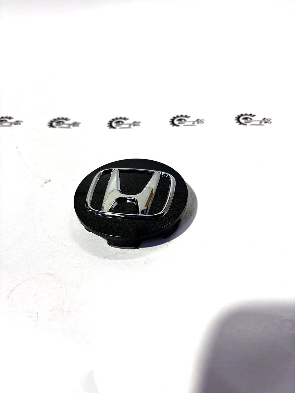 Honda wheel center cap assembly in aluminum with Honda branding, designed for compatibility with specific Honda vehicle wheels.
