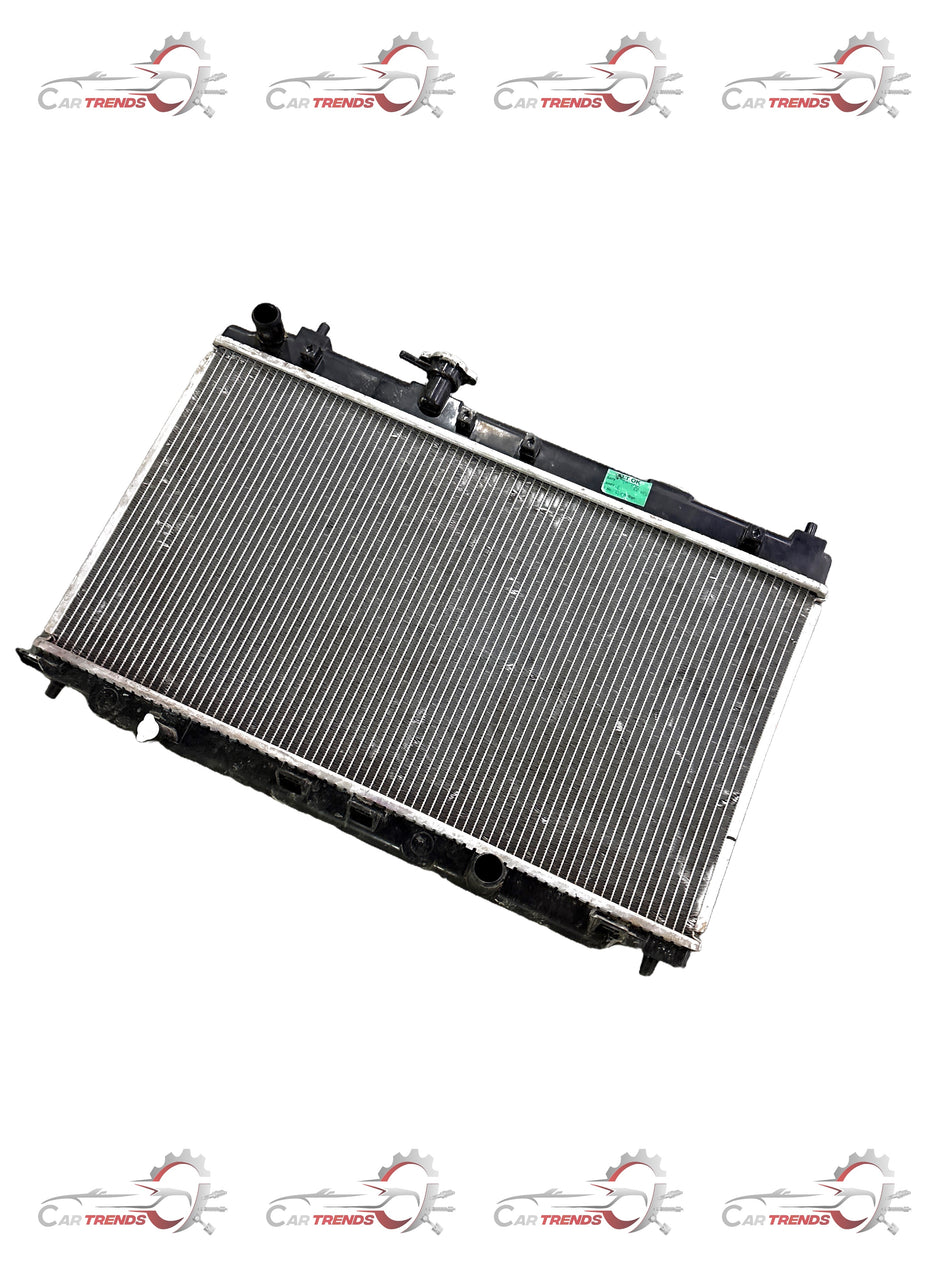 Honda radiator component 19010REJW01, compatible with Honda vehicles, shown in the image with detailed metal fins and connectors.
