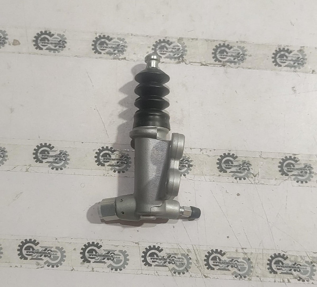 Honda slave cylinder assembly 46930SNAA41, automotive brake component with visible metal cylinder and hydraulic fittings.