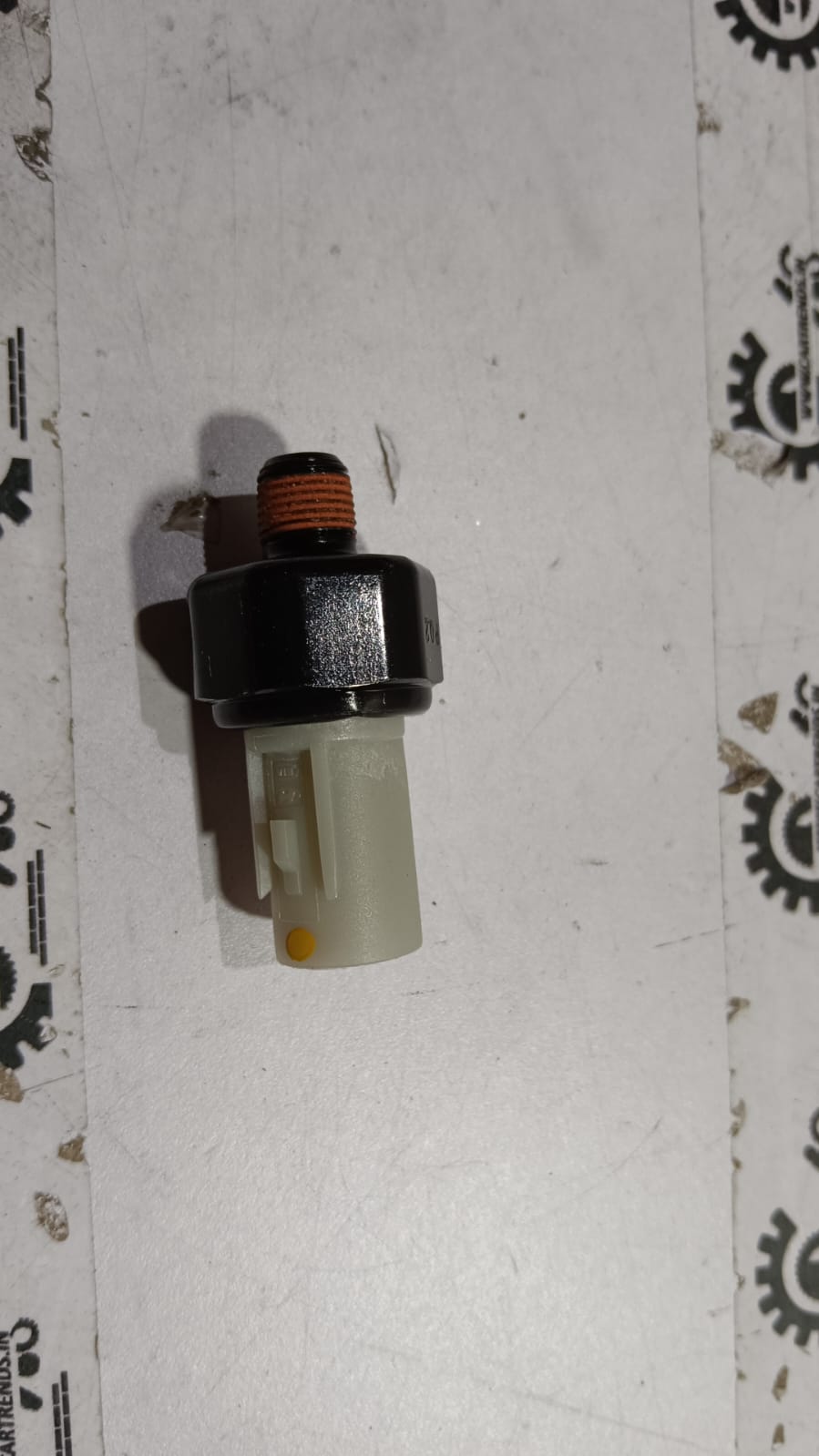 Hyundai oil pressure switch for Santro Xing, showing the black automotive sensor with wiring connector.