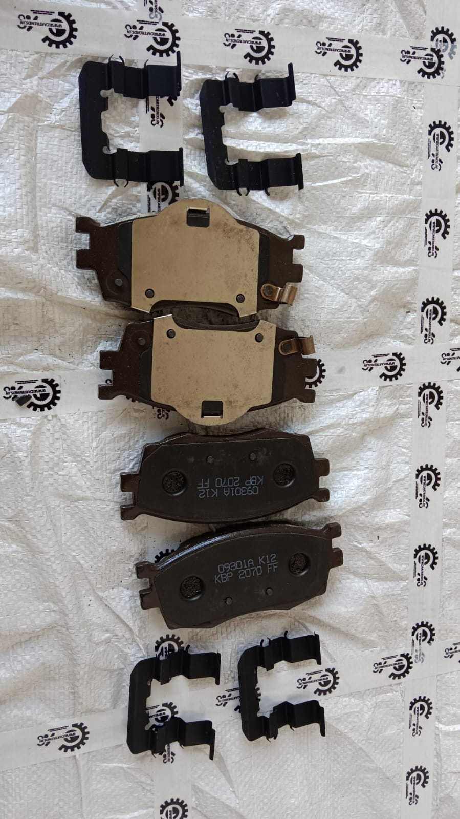 Hyundai i20 front brake pad, part number 581011JA10, showing the brake pad installed in a vehicle.