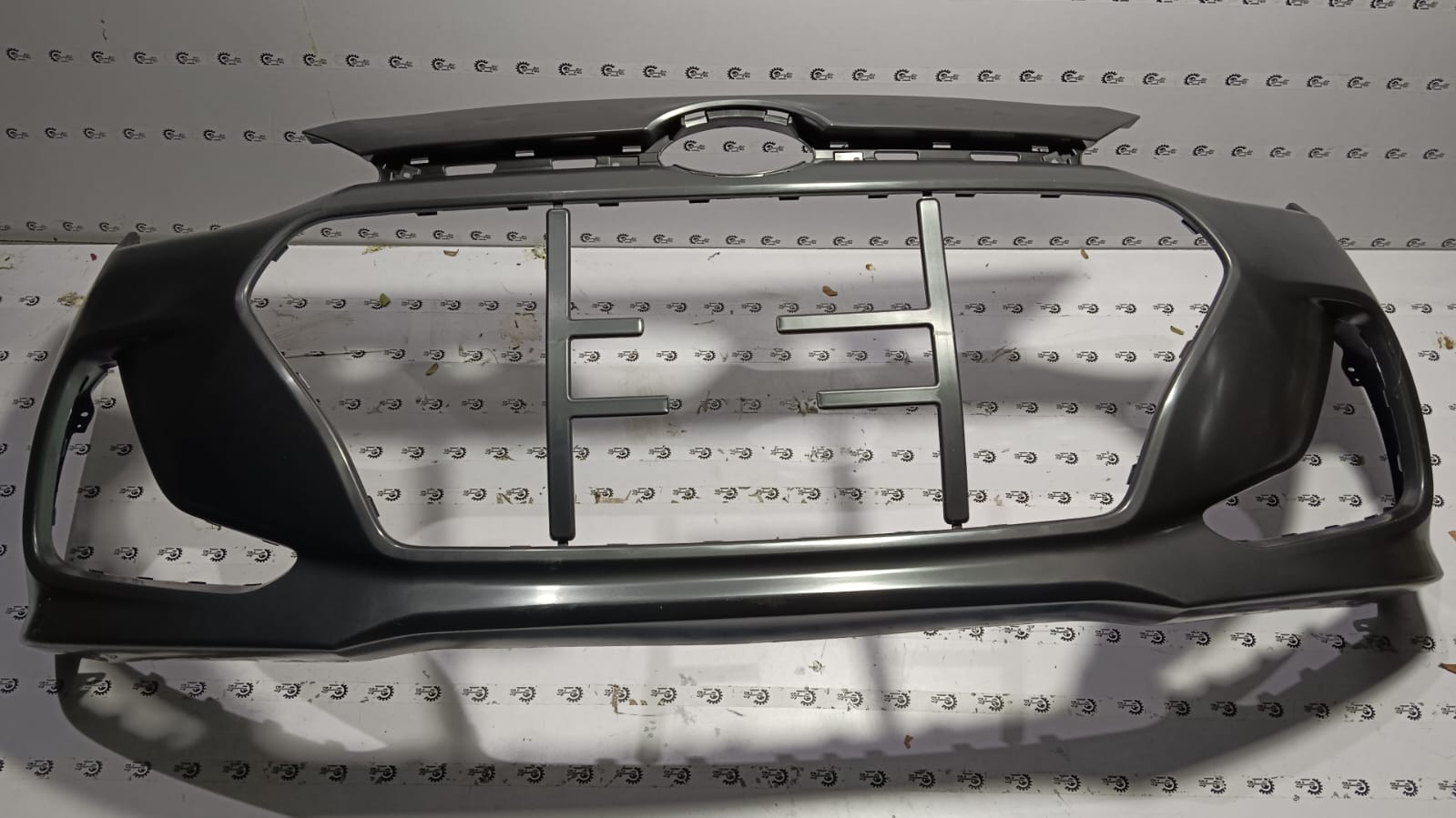 Front bumper for Hyundai Grand i10, model type 2, with part number 86511B4500, shown in a close-up view.
