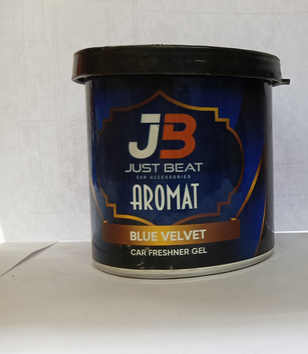 Blue velvet car refresher gel by JB, compact container with the JB logo, designed for freshening vehicle interiors.