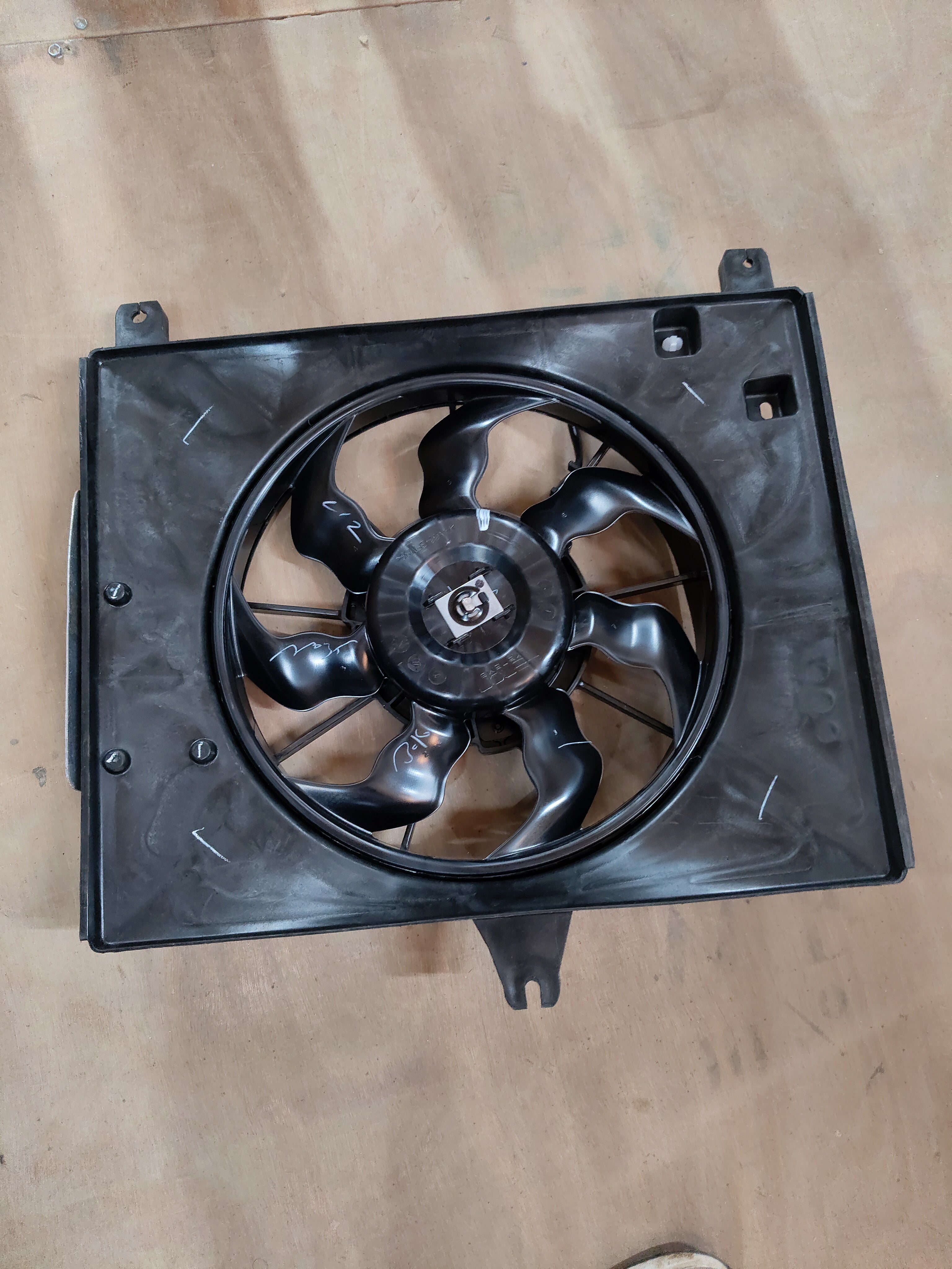 Maruti Suzuki engine cooling fan assembly 17100M67LD0 showing the fan and mounting components.