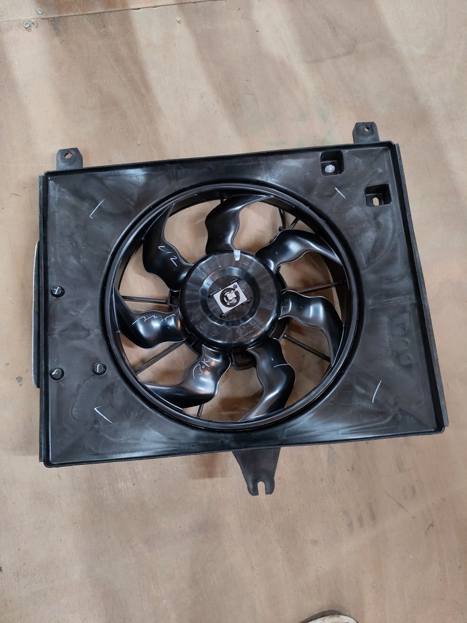 Maruti Suzuki engine cooling fan assembly 17100M67LD0 showing the fan and mounting components.