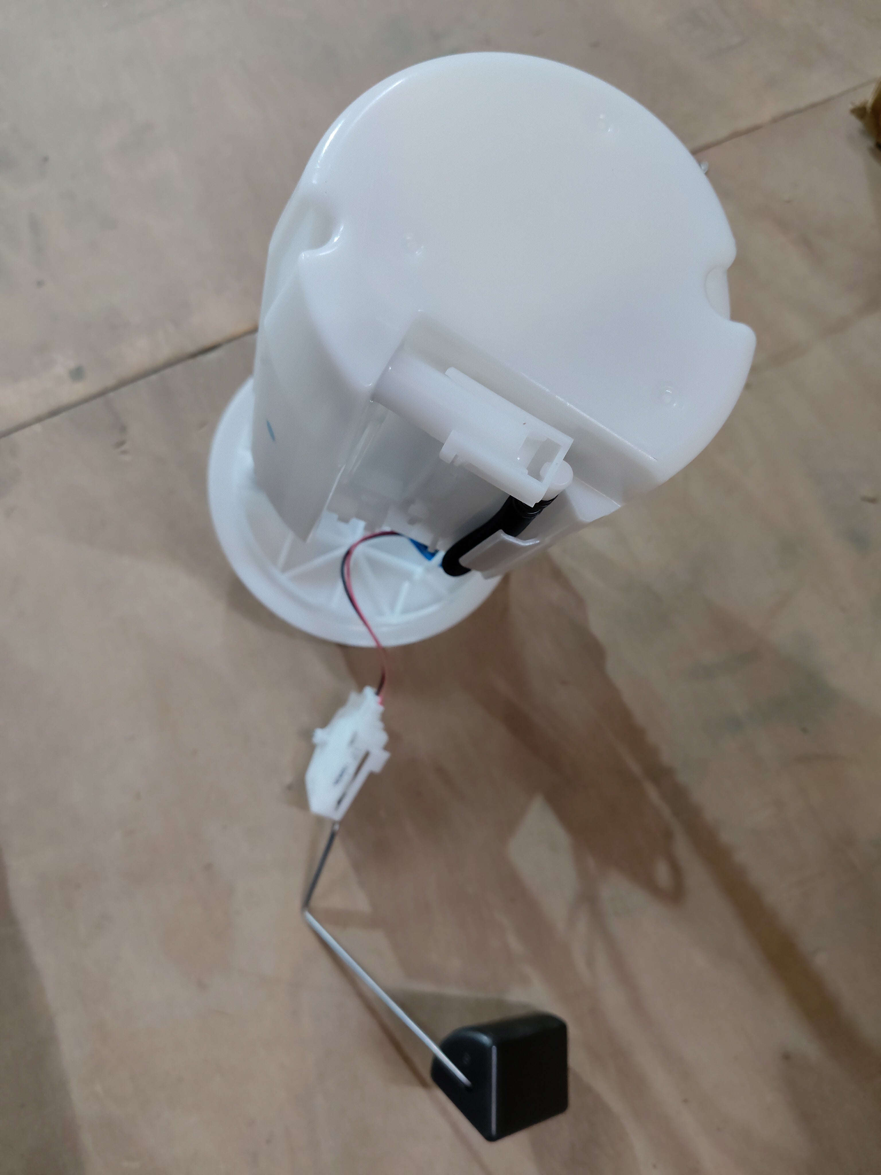 Maruti Suzuki fuel pump for Celerio 2nd generation, part number 15100M69R02, shown in a close-up image.