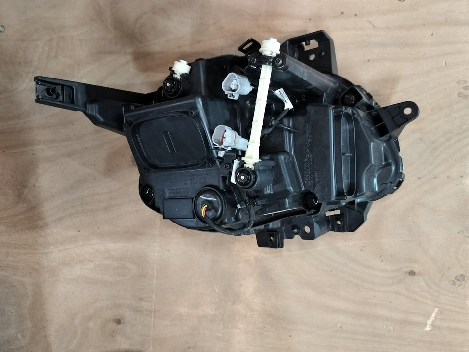 Maruti Suzuki headlamp assembly for Fronx, front left side with clear lens and mounting brackets.
