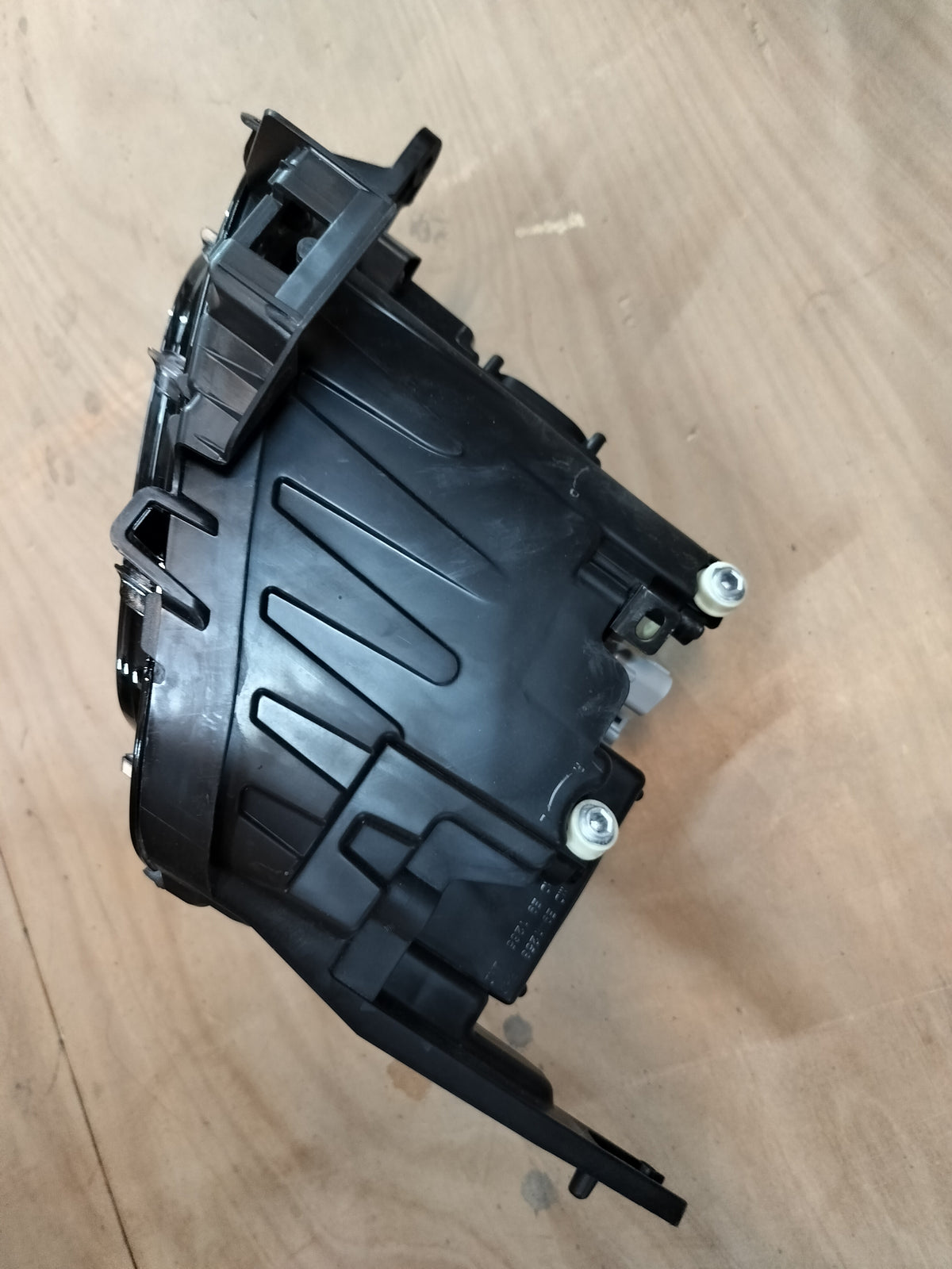 Maruti Suzuki front headlamp assembly for Fronx model, showing the headlamp with clear lens and mounting brackets.