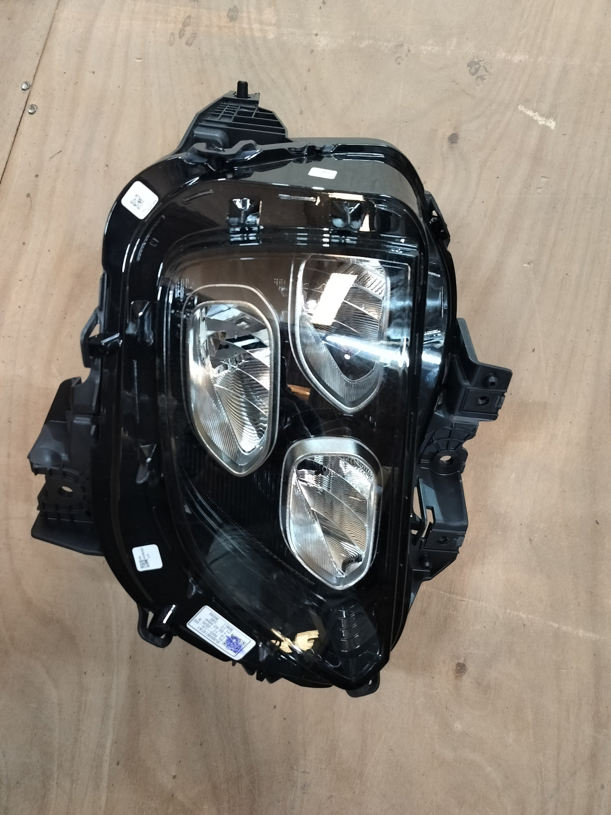 Maruti Suzuki headlamp assembly for Fronx, front left side, vehicle lighting component with clear lens and mounting brackets.