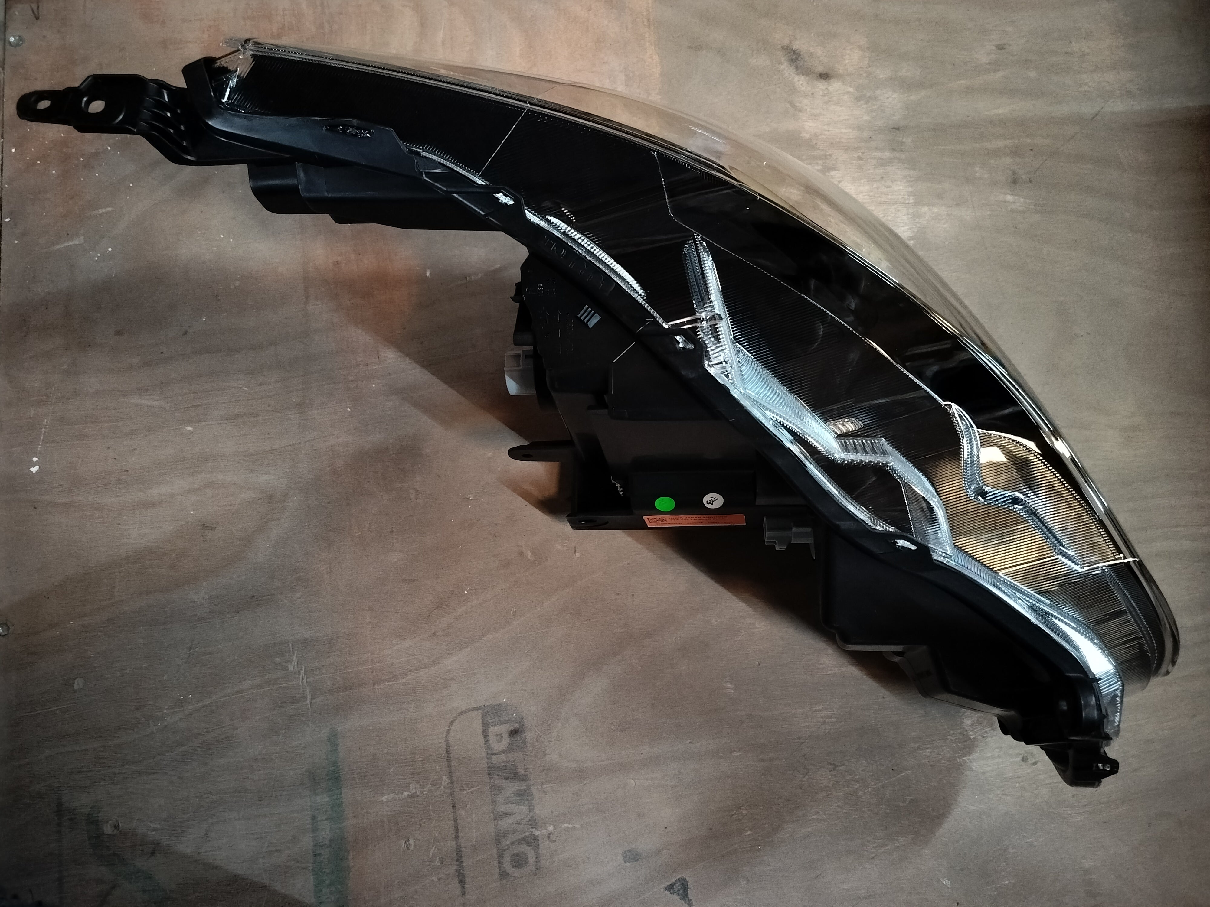 Maruti Suzuki headlamp assembly left side, part number 35300M55T42, showing the front view of the vehicle's headlight unit.