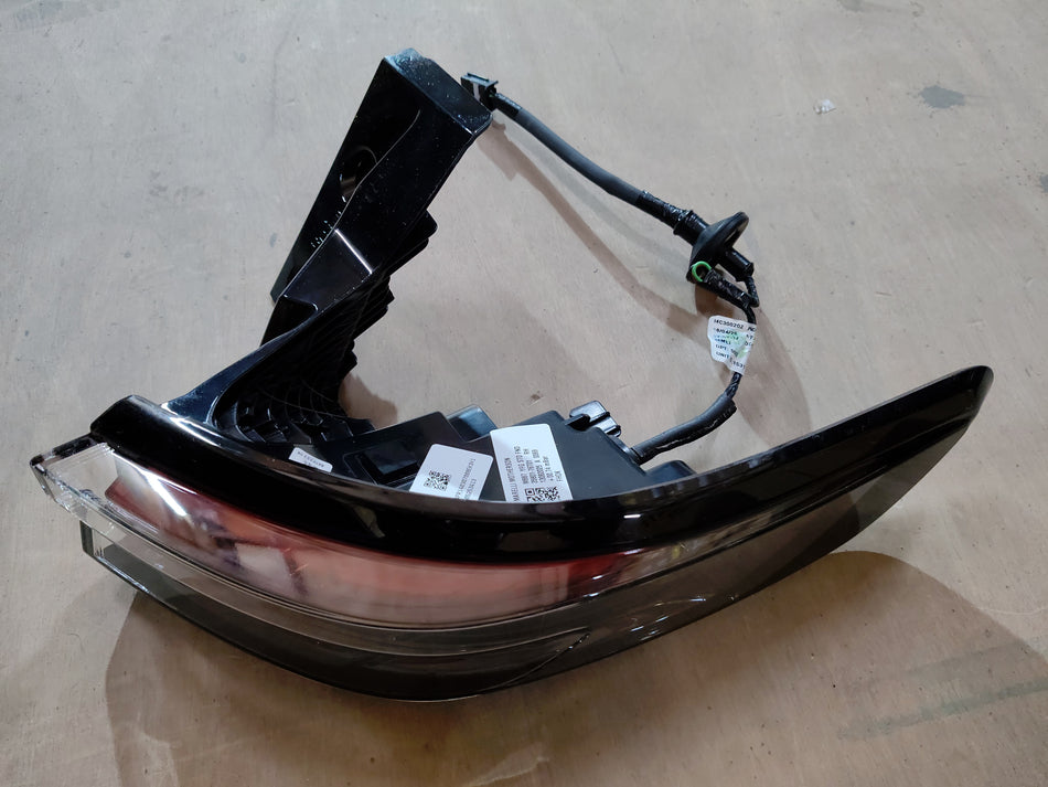 Maruti Suzuki tail lamp and stop light assembly for vehicle, featuring clear lens and electrical components.