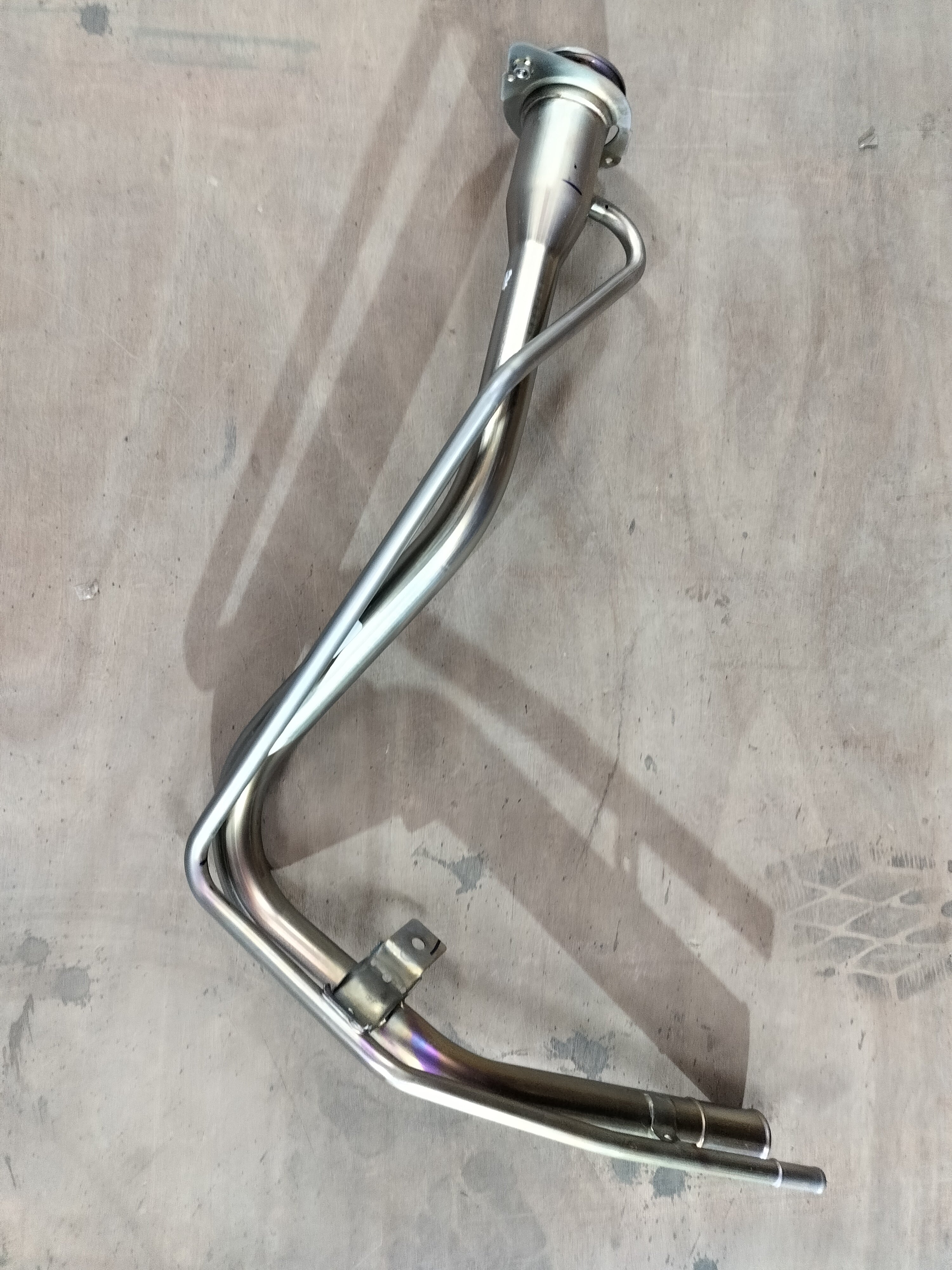 Maruti Suzuki Neck Compfuel Filler 89210M62S00 showing the fuel filler neck and surrounding area of the vehicle