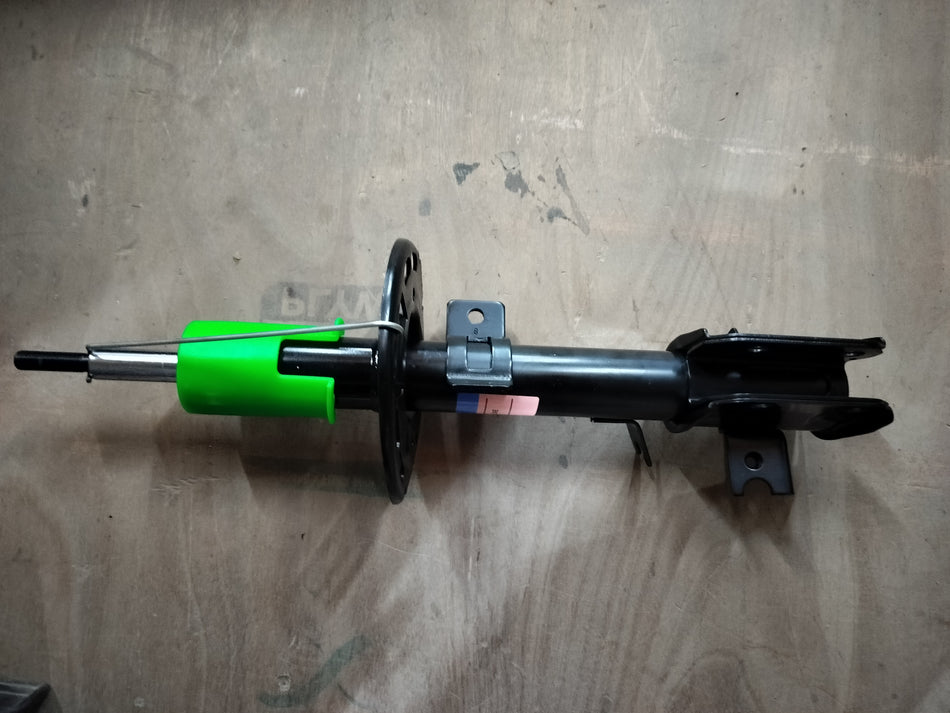 Front left strut assembly for Maruti Suzuki vehicle, showing the suspension component with mounting details.