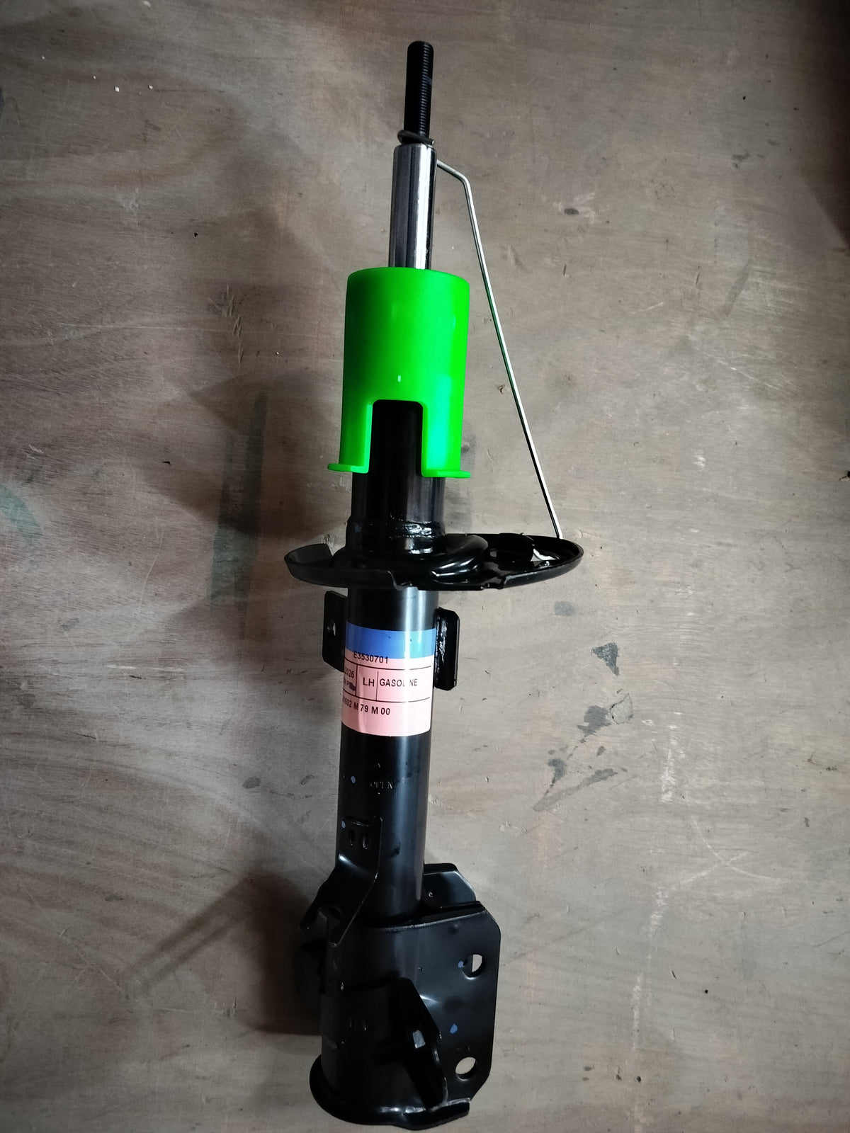 Front left strut assembly for Maruti Suzuki vehicle, part number 41602M79M01, showing the suspension component in detail.