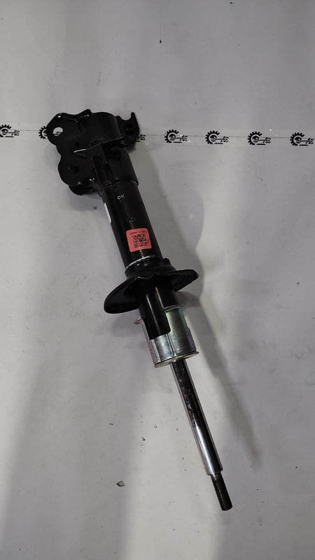 Front strut assembly for Maruti Suzuki vehicle, showing the suspension component with coil spring and mounting points.